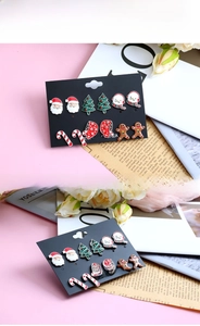 Detail view of 6-pair Christmas stud earring set featuring Santa and snowmen on card