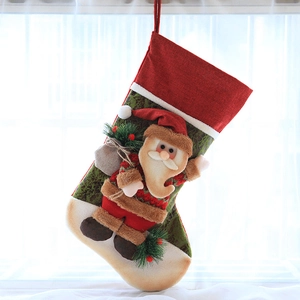 Close-up of a festive Christmas stocking with 3D Santa Claus figure and pine accents