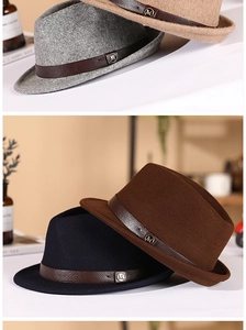 Detailed stack of wool felt fedora hats in grey and khaki with leather belts and metal M buckles