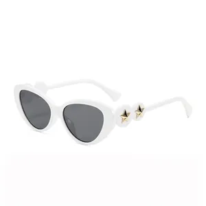 White cat-eye sunglasses with dark grey lenses and gold star accents on the frame