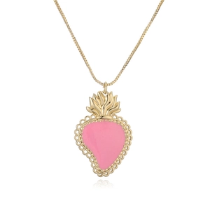 Golden necklace with pink enamel heart pendant and crown detail on white background