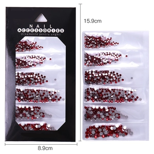 Mixed size deep red flatback nail rhinestones set in a 15.9cm x 8.9cm display pack