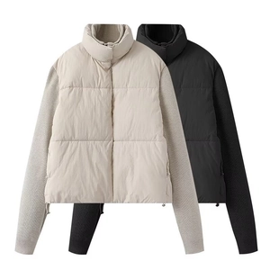 Detailed close-up of knit sleeve texture and contrast stitching on padded puffer jacket