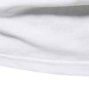 Close-up of white pique cotton fabric showing breathable mesh texture and double stitching