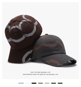 Detailed close-up of distressed cotton twill baseball caps with vintage spray ring prints