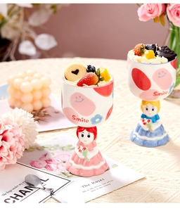 Detail of cute hand-painted ceramic goblet cups with smile pattern and character base