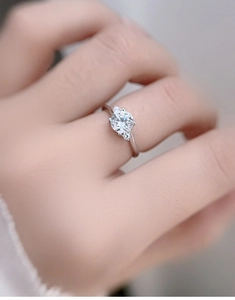 Detailed view of a three-stone moissanite engagement ring set in S925 sterling silver