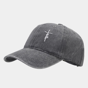 Detailed view of white 'Faith' embroidery on vintage washed charcoal baseball cap fabric
