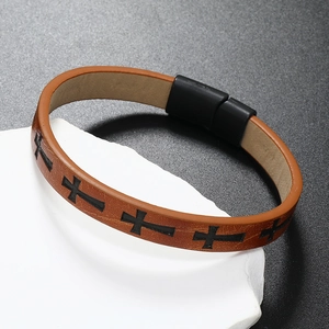 Close-up of brown braided leather bracelet with black cross pattern and magnetic clasp