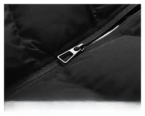 Detailed macro view of the premium smooth metal zipper and windproof black fabric