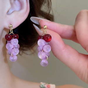 Macro shot of purple resin grape tassel earrings with gold-plated silver needle studs