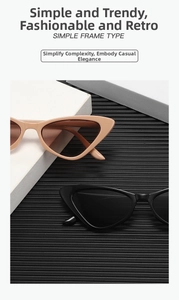 Occhiali da sole retrò cat-eye neri e beige esposti su una superficie strutturata