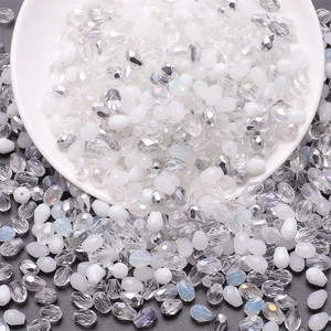 Mixed color 6x8mm teardrop glass beads in a white bowl for DIY jewelry making