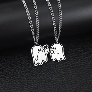 Ghost matching necklaces for couples with heart detail on black leather background
