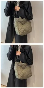 Detail showing olive green quilted nylon texture and diamond pattern on tote bag