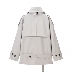 Detail of short trench coat back featuring double-layer storm flap and waist belt