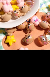 Close-up of colorful resin bear and star beads for DIY jewelry making and phone chains