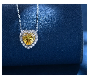 Macro shot of heart-shaped yellow gemstone pendant with silver micro-pave setting