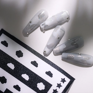 Coffin-shaped press-on nails with marble grey finish and glitter butterfly accents