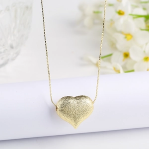 Elegant gold heart pendant necklace with matte sandblasted finish on delicate box chain