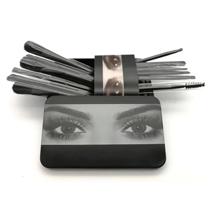 12-piece black makeup brush set in a matching portable metal storage tin box