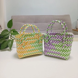 Close-up of woven basket bags in colorful patterns and handmade texture details