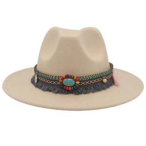 Detail of bohemian woven band with turquoise and tassels on a beige fedora hat
