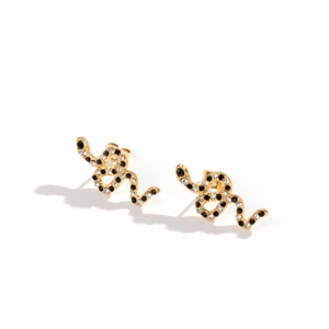 Minimalist gold snake stud earrings with black and white pavé crystals on white backdrop