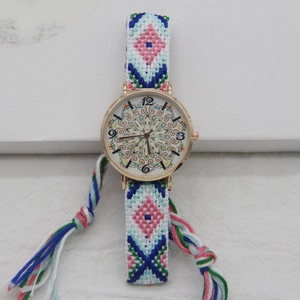 Detail of bohemian hand-woven strap watch featuring pink geometric patterns and mandala dial
