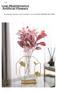 Close-up of Morandi vase with gold metal bird frame and artificial red leaves