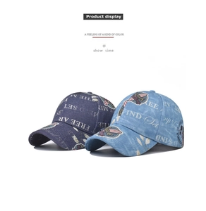 Detail view of vintage washed denim baseball caps in dark and light blue with retro prints