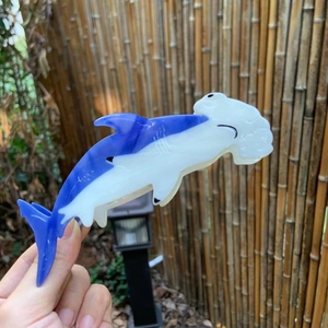 Detailed view of ocean-themed hammerhead shark hair claw clip in navy and pearl white