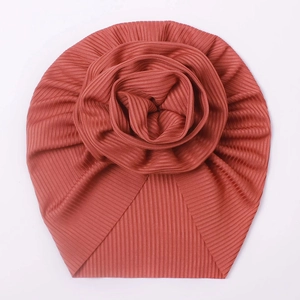 Detailed macro view of the 3D flower decoration on a rib-knit baby turban hat