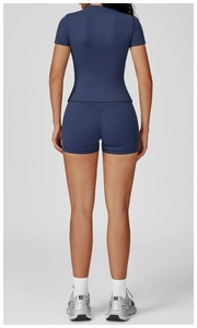 Detail of high-waist navy yoga shorts with V-cut back design for booty lifting effect
