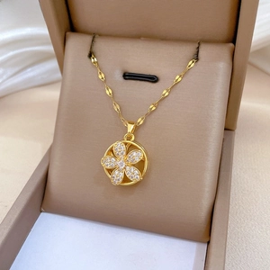 Detailed close-up of a rotating five-petal flower pendant necklace with shimmering crystals