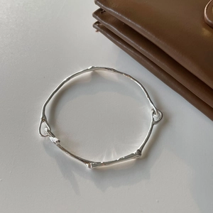 Minimalist S925 sterling silver irregular bangle featuring artistic organic texture