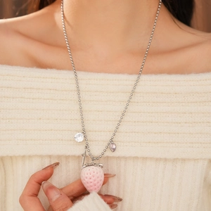 Detailed view of a sweet strawberry pendant necklace with heart stones on a silver chain