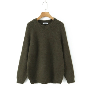 Deep green crewneck mohair knit sweater in a loose fit hanging on a wooden hanger