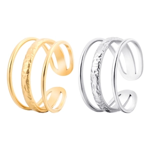 Detailed view of gold and silver layered open rings with hammered metal texture finish