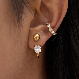 Gold C-hoop stainless steel earrings with sparkling zircon crystals on a female model
