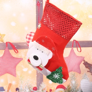 Detail of a red Christmas stocking featuring a white bear head and sequin decorations