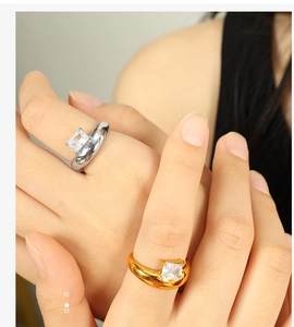 Detailed close-up of gold and silver irregular rings with square zirconia stones