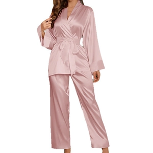 Women's pink satin pajama set featuring long-sleeved kimono top and matching pants