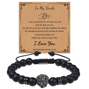 Detail of matte black stone bead bracelet with lion head charm on uncle gift card