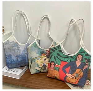 Three artistic oil painting canvas tote bags with various prints in a lifestyle setting
