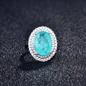 Macro shot of oval Paraiba tourmaline style ring with double halo pavé diamonds