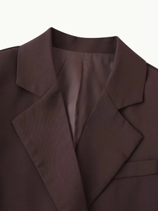 Close-up of lapel collar and fine twill fabric texture on coffee brown blazer jacket