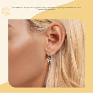 Close-up of a model wearing a S925 sterling silver dachshund dog charm hoop earring