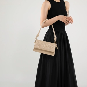 Elegant beige quilted crossbody bag for women with knotted shoulder strap detail