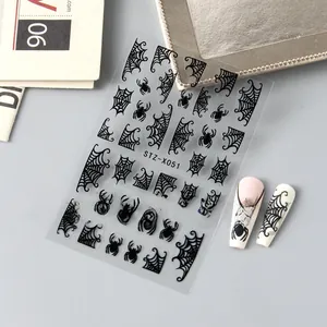 Macro detail of 3D Halloween nail stickers with black spiders and cobweb patterns
